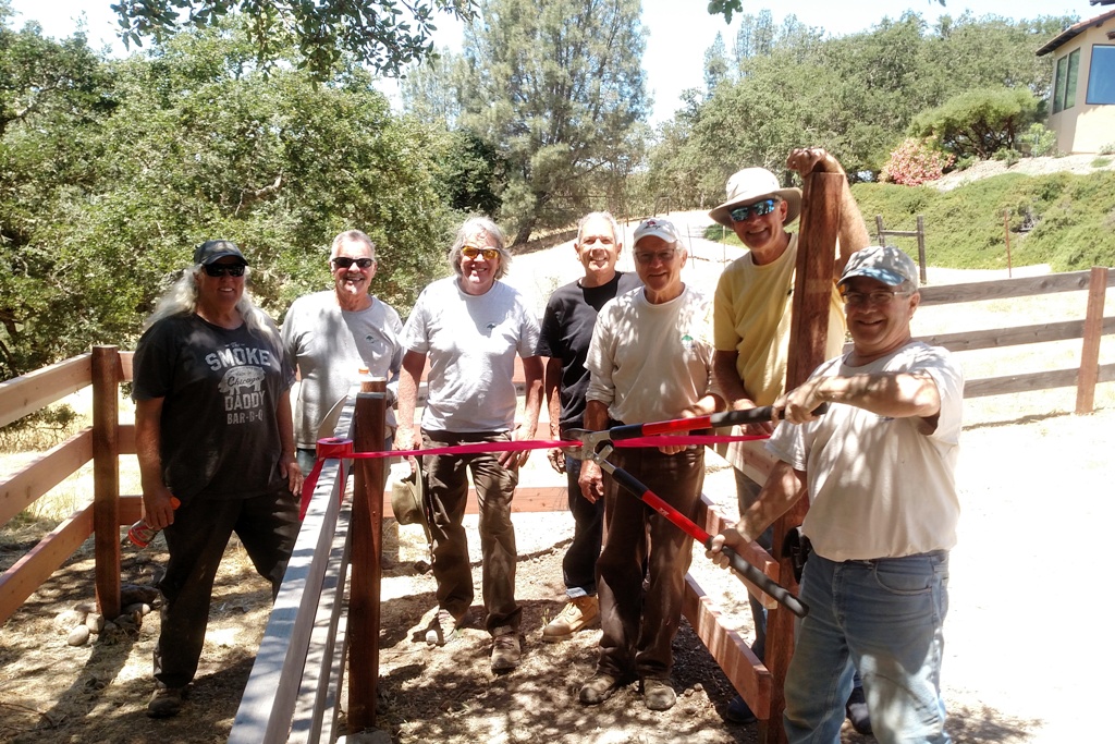 Trail Crew having a ribbon cutting for the new entry way.